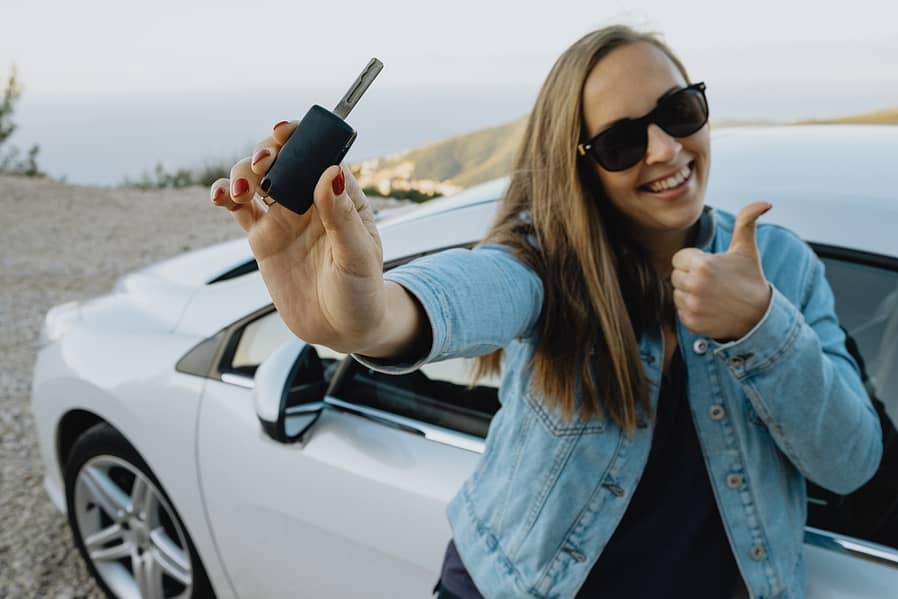 Happy Young Woman Showing new Rental car keys